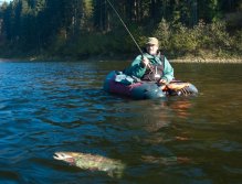 Rainbow and Fly Fisherman in the Belly Boat